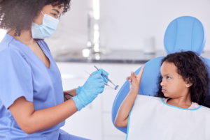 Cranky little girl waving her finger at her dentist