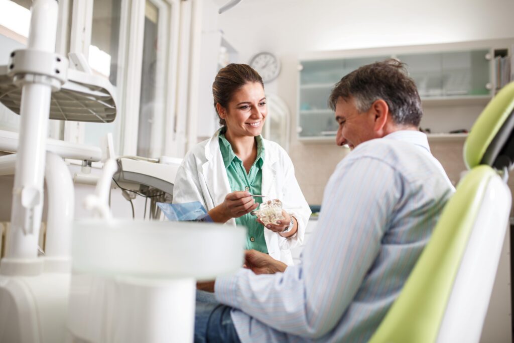 Dentist smiling at patient in treatment chair